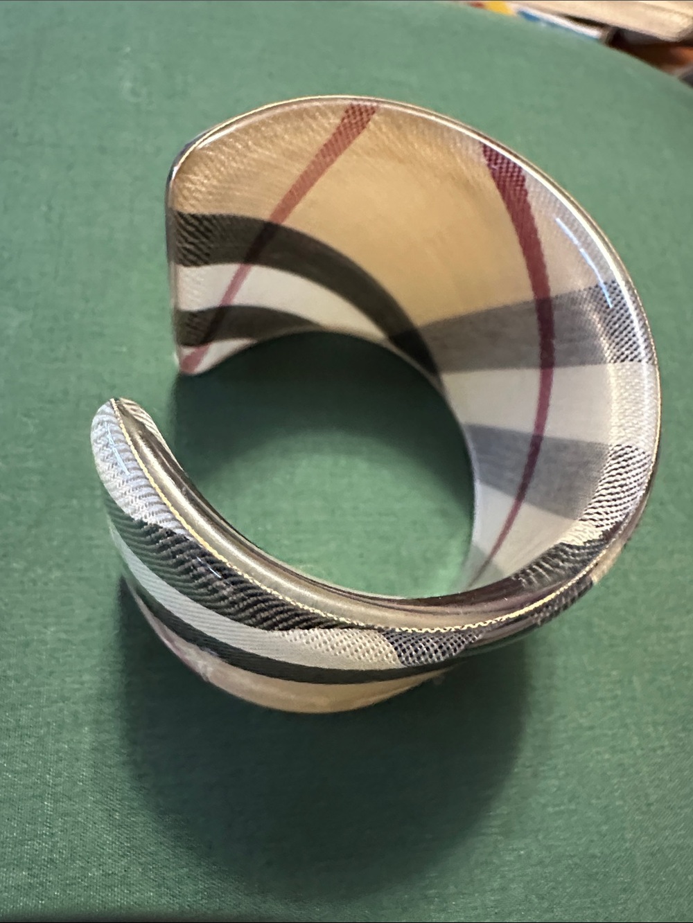 Acrylic cuff bracelet features iconic beige  check pattern.